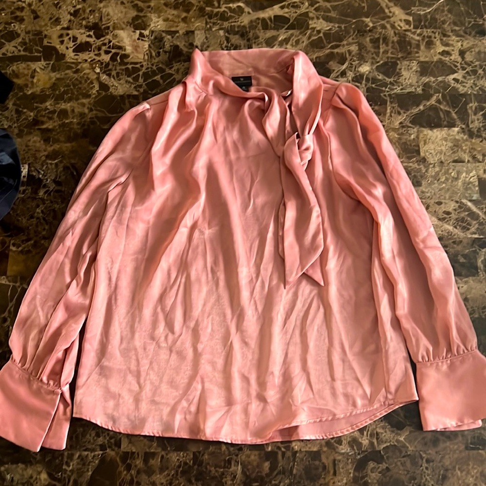 A loosely fitted, pink blouse